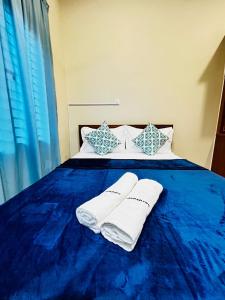 Postel nebo postele na pokoji v ubytování Kempadang Courtyard Homestay - Kuantan