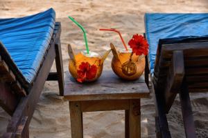 two drinks in pumpkins sitting on a table at Vaaru Beach Villa in Kosgoda