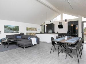 a kitchen and living room with a table and chairs at 10 person holiday home in Jerup in Jerup