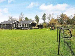 a yard with a playground and a house at 5 star holiday home in Jerup in Jerup