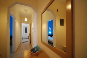 a hallway with a mirror and a room with a bed at Thalassenia Studios & Apartments 3 in Hanioti