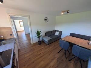 a living room with a table and a couch at Ferienwohnung am Bauernhof, Seeblick, Bergpanorama in Keuschen