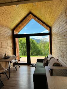 a living room with a large window and a couch at Challet44 in Jeseník