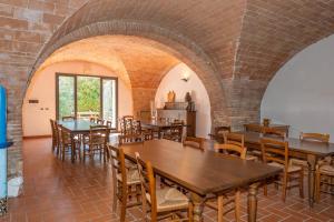 a room with tables and chairs and a brick wall at Agriturismo Antica Fonte in Rosignano Marittimo