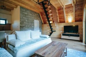 a living room with a couch and a table at Ski Vista house in Žabljak