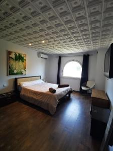 a bedroom with a large bed with a coffered ceiling at Villa Hawai in Benidorm +7 photos