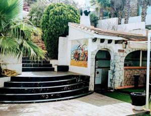 a building with stairs and a painting on the wall at Villa Hawai in Benidorm