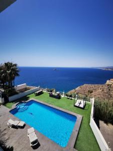 a swimming pool with a view of the ocean at Villa Hawai in Benidorm