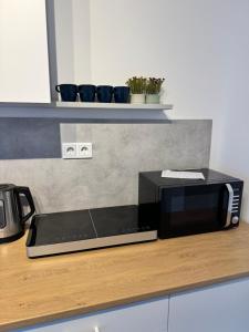 a black microwave sitting on top of a kitchen counter at Duisburg Flats 24 in Duisburg