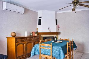 a kitchen with a table with a blue table cloth at Family house with beautiful garden in Saint-Hippolyte