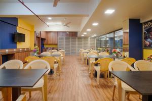 a dining room filled with tables and chairs at HOTEL SHITAL INN in Ahmedabad