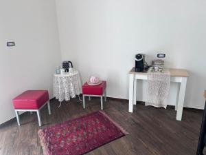 a room with two tables and two chairs and a rug at Al centro exclusive apartment in Brindisi