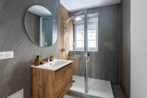 a bathroom with a sink and a mirror at Automobile in Mulhouse