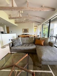 a living room with a couch and a table at VILLA PINECOVE - Vacation STAY 24656v in Kamogawa