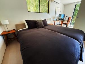 a bedroom with a large bed in a room at VILLA PINECOVE - Vacation STAY 24656v in Kamogawa