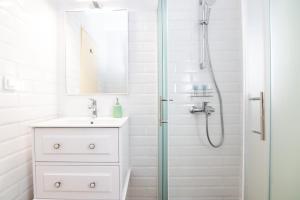a white bathroom with a sink and a shower at House Bianca with garden in Malinska +47 photos