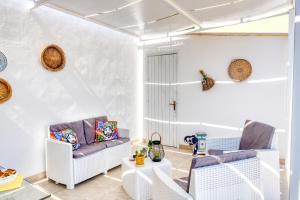 a living room with two chairs and a table at Annina'S Home Panoramic sea view By Sicily Home Solutions in Castellammare del Golfo