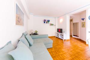 a living room with a couch and a television at Via Tre Scalini 1A in Santa Margherita Ligure
