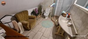 an overhead view of a bathroom with a toilet and a chair at Vilimu Sodyba - Outdoor Hot Tub in Kriukai +12 photos