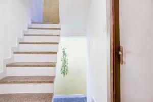 a staircase in a house with blue and white walls at Hotel O Bine Venue in Bhopal