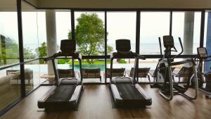 a gym with cardio machines and a large window at Baan Thew Talay Blue Sapphire in Cha Am