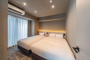 Postel nebo postele na pokoji v ubytování Apartment Hotel 11 Asakusa 2