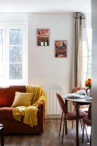 a living room with a couch and a table at Alsace in Mulhouse