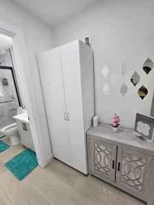 a bathroom with a large white cabinet and a table at Cozy Modern Spacious 2 Bedroom and full kitchen in Southwest Calgary in Calgary +47 photos