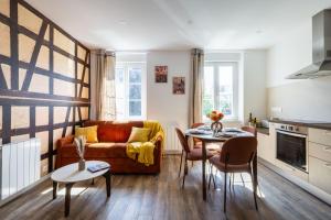 a living room with a couch and a table at Alsace in Mulhouse