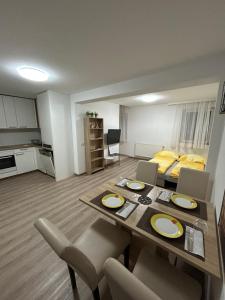 a living room with a table and chairs and a bed at Urban Stay Kremsmünster Premium Apartment in Kremsmünster