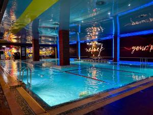 a swimming pool on a cruise ship at night at Stadium Park Hotel in Odesa