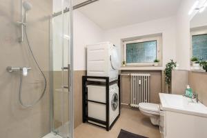 a bathroom with a shower and a toilet and a sink at Komfortable Wohnung mit Terrasse für 5 Personen! in Baesweiler +22 photos