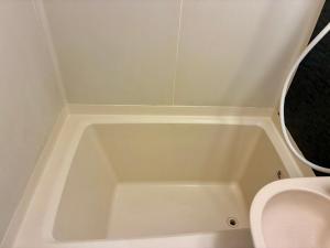 a white bath tub in a bathroom with a toilet at Corpo SKR by Tranova in Musashino +26 photos