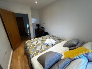 a bedroom with a bed with pillows on it at Secure 2BD Retreat: Modern Comfort in Privacy in Chatham
