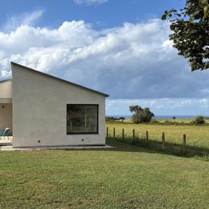 a building with a window on the side of a field at Barrio del Norte in Villademoros