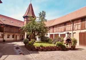 a large building with a clock tower in a courtyard at SanMar 1 Ferien und Wohnpark Residenz in Meisdorf