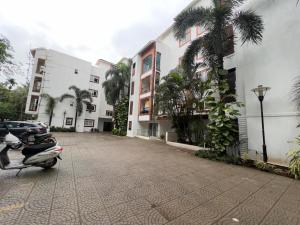 a scooter parked in a parking lot next to buildings at 1 BHK in Arpora, Baga, Calangute in Arpora