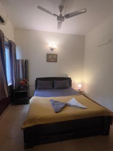 a bedroom with a large bed with a ceiling at 1 BHK in Arpora, Baga, Calangute in Arpora