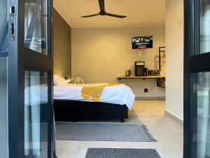 a bedroom with a bed with a ceiling fan at Casa Bravo - Cozy Traveller in Pretoria