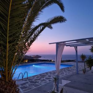 a view of a swimming pool at dusk at Bellevue Village ''Αdults Only'' in Agia Pelagia