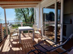a patio with a table and chairs on a deck at Camping San Michele in Moniga