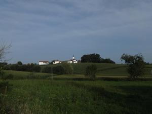 a field with a house on top of a hill at Maison Goexenia Etcharry 2 chambres in Etcharry +4 photos