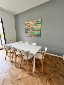 a dining room with a white table and chairs at Duisburg Flats 24 in Duisburg