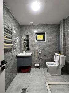 a bathroom with a sink and a toilet at Harmony Escape in İsmayıllı
