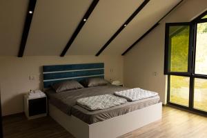 a bedroom with a large bed in a attic at Harmony Escape in İsmayıllı +57 photos