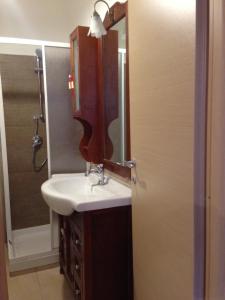 a bathroom with a sink and a mirror at Villa Malandrino Guest House in Agropoli