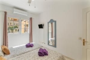 a bedroom with two beds with purple slippers on them at Los Mangueros Beach 6 - Mogán in Puerto de Mogán +16 photos