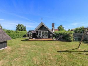 a house with a large yard in front of it at Holiday Home Elbert - 100m from the sea by Interhome in Otterup