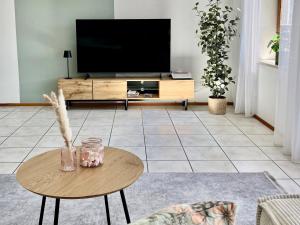 a living room with a tv and a table at SeeSternchen in Überlingen