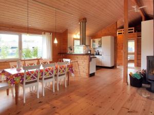 a kitchen and dining room with a table and chairs at Holiday Home Karanfilka - 900m from the sea by Interhome in Gedser